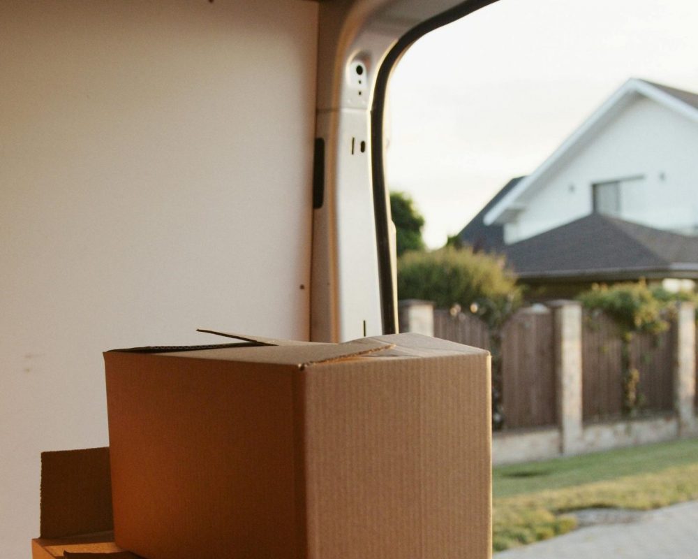 View inside a delivery van with stacked cardboard boxes ready for moving.